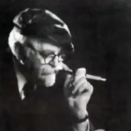 August Aichhorn in old age, with a pipe and an open book; photographer and date unknown